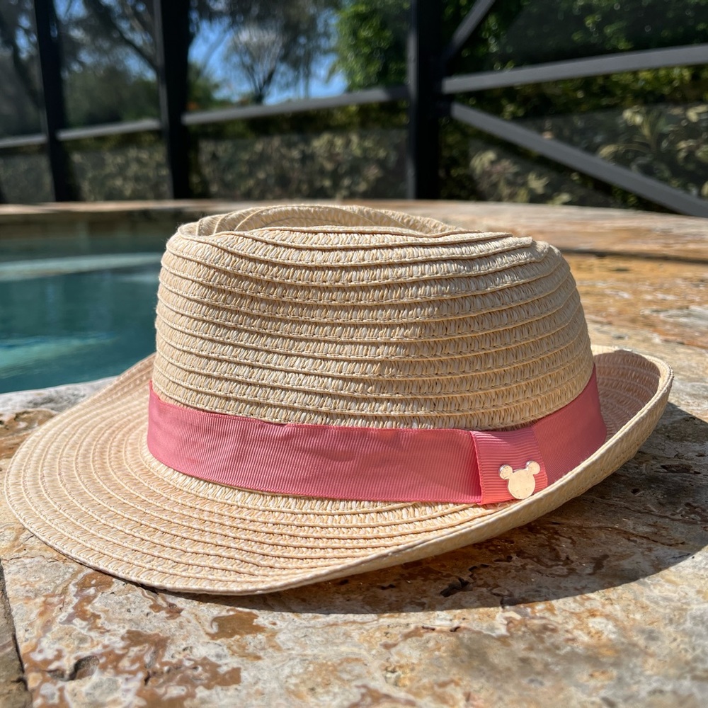 Disney adult women’s fedora straw hat with a pink hatband and Mickey medallion.